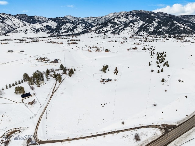 snowy aerial view with a mountain view