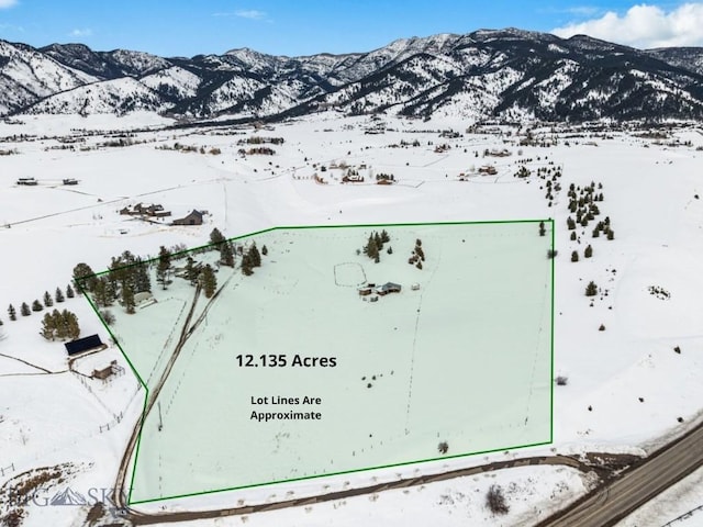 snowy aerial view featuring a mountain view