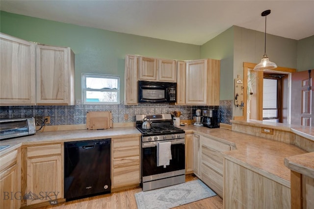 kitchen featuring black appliances, light brown cabinetry, backsplash, a peninsula, and light countertops