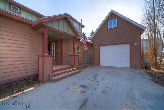 view of home's exterior featuring an outbuilding, board and batten siding, and driveway