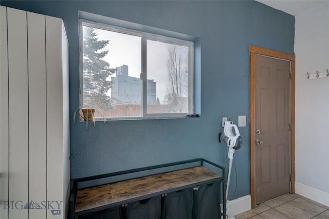 interior space with light tile patterned floors and baseboards