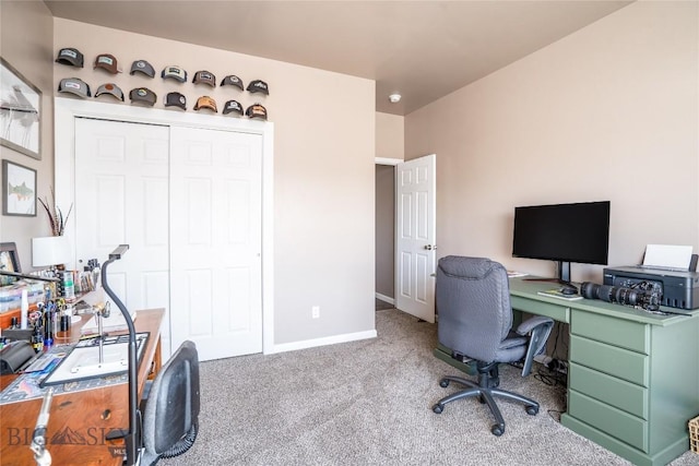 carpeted home office featuring baseboards