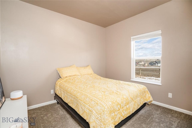 carpeted bedroom featuring baseboards