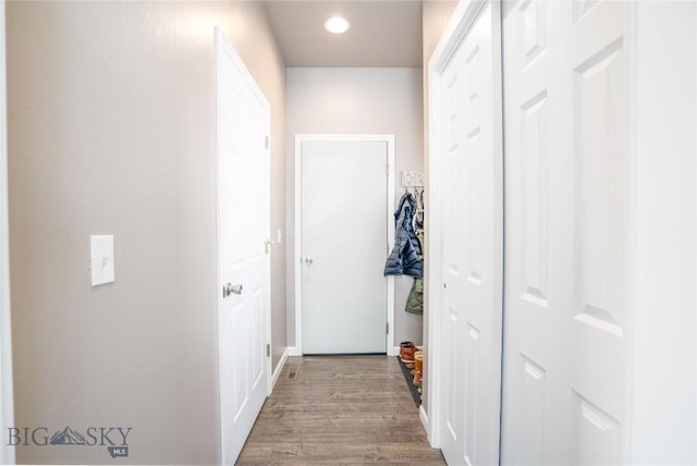 hall with recessed lighting and wood finished floors