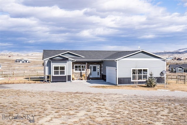 view of front of house with a garage and fence