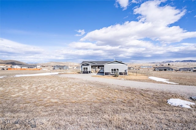 view of yard with a mountain view and fence