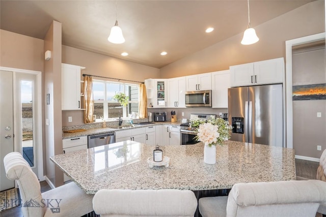 kitchen with white cabinetry, stainless steel appliances, and a sink