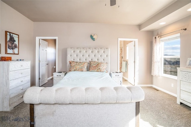 bedroom with carpet flooring, ensuite bath, and baseboards