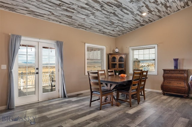 dining space with plenty of natural light, french doors, lofted ceiling, and wood finished floors