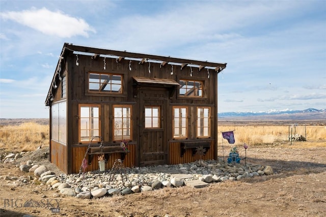 back of property featuring an outbuilding