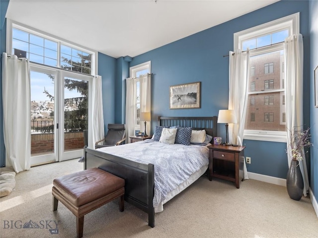 bedroom with carpet floors, multiple windows, baseboards, and access to outside