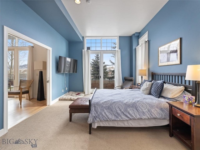 carpeted bedroom with baseboards and access to outside