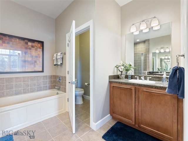 bathroom featuring tile patterned flooring, a shower stall, toilet, a bath, and vanity