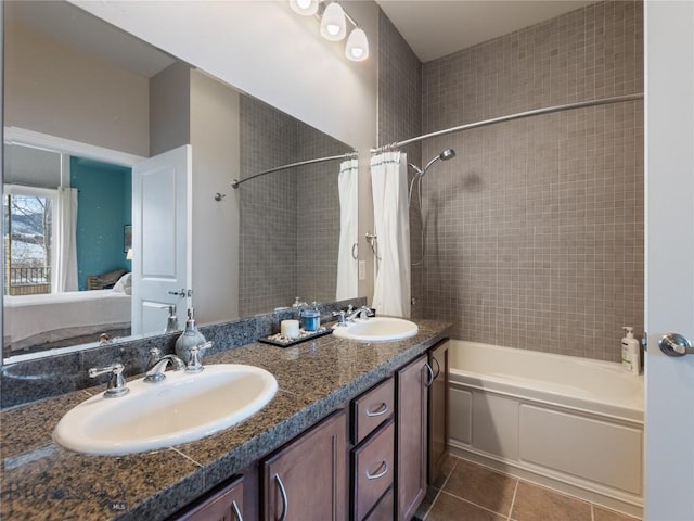 bathroom with a sink, tile patterned flooring, ensuite bathroom, and shower / bath combination with curtain