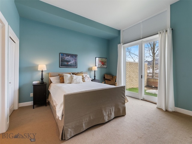 bedroom with access to outside, carpet flooring, and baseboards