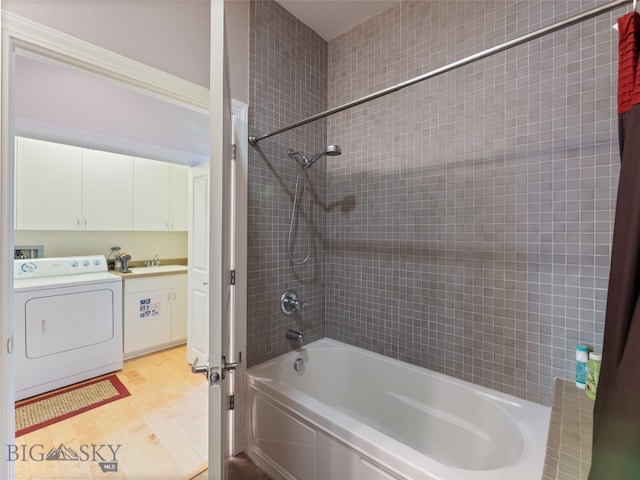 full bath with vanity, washer / dryer, bathing tub / shower combination, and wood finished floors