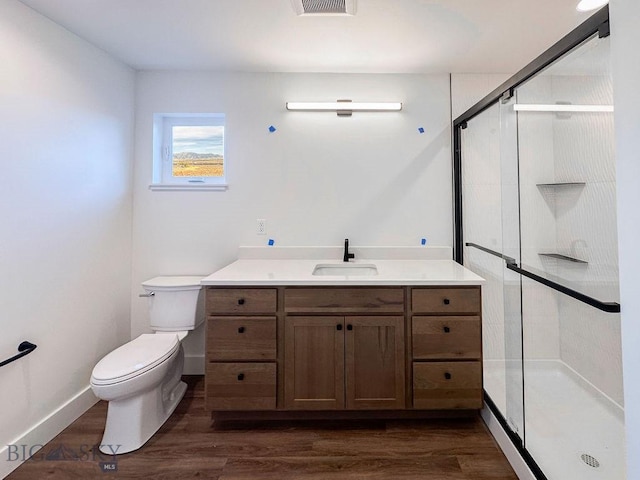 full bathroom with vanity, toilet, wood finished floors, and a shower stall