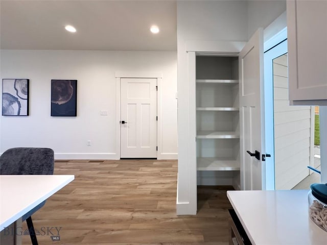 office featuring recessed lighting, light wood-style flooring, and baseboards