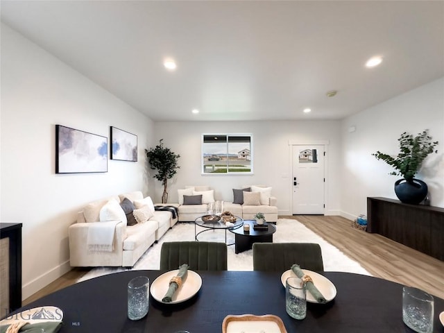 living room featuring recessed lighting, wood finished floors, and baseboards