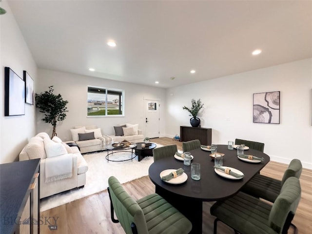 dining area featuring recessed lighting, baseboards, and light wood finished floors