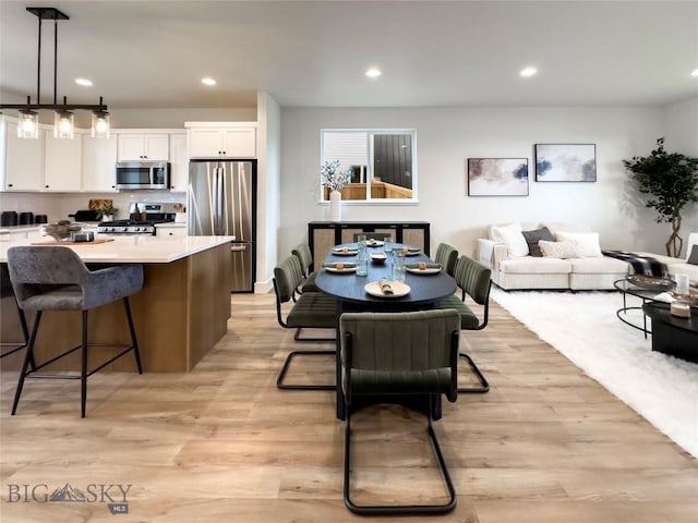 dining space featuring recessed lighting and light wood finished floors