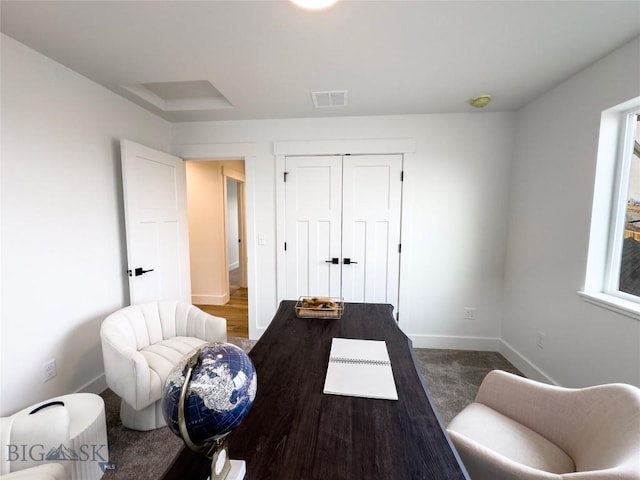 office space featuring carpet flooring, baseboards, and visible vents