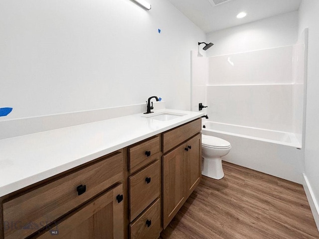 full bathroom featuring vanity, wood finished floors, recessed lighting, bathtub / shower combination, and toilet