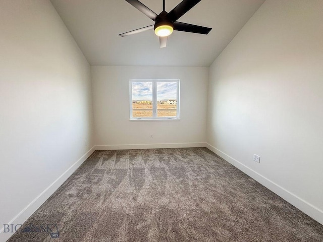 spare room featuring baseboards, ceiling fan, carpet flooring, and vaulted ceiling