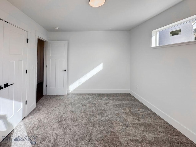 unfurnished bedroom featuring baseboards and carpet flooring