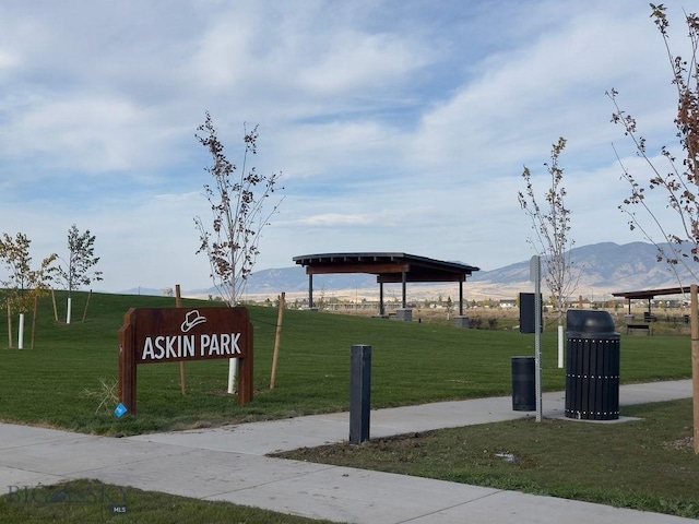 view of home's community with a mountain view and a lawn