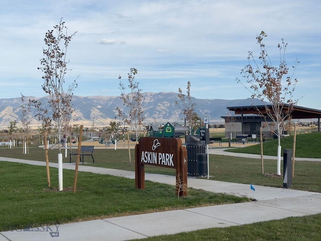 view of property's community with a mountain view and a yard