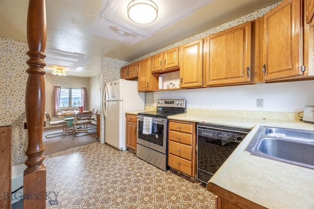 kitchen featuring wallpapered walls, stainless steel electric range, freestanding refrigerator, light countertops, and dishwasher