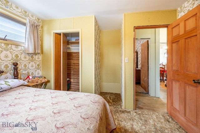 carpeted bedroom with wallpapered walls