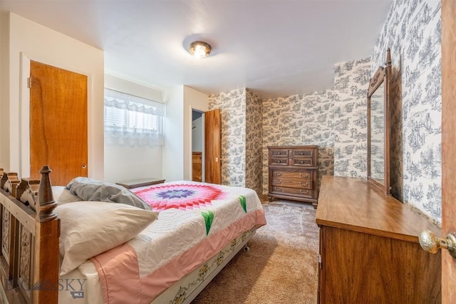 bedroom featuring wallpapered walls and carpet flooring