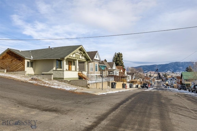 view of front of property with a residential view and a mountain view