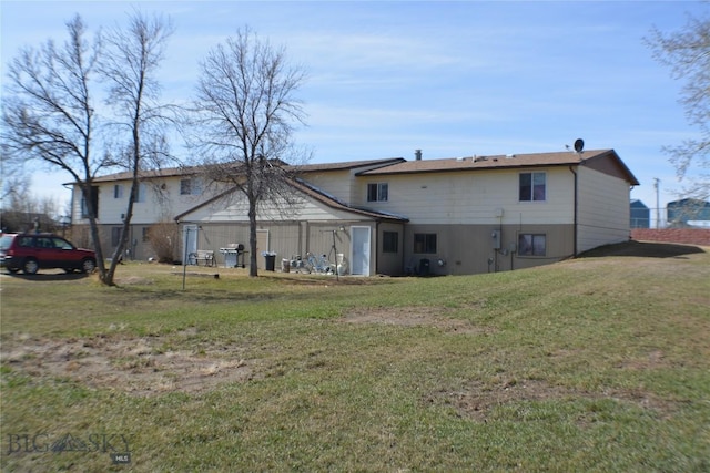 rear view of property with a lawn