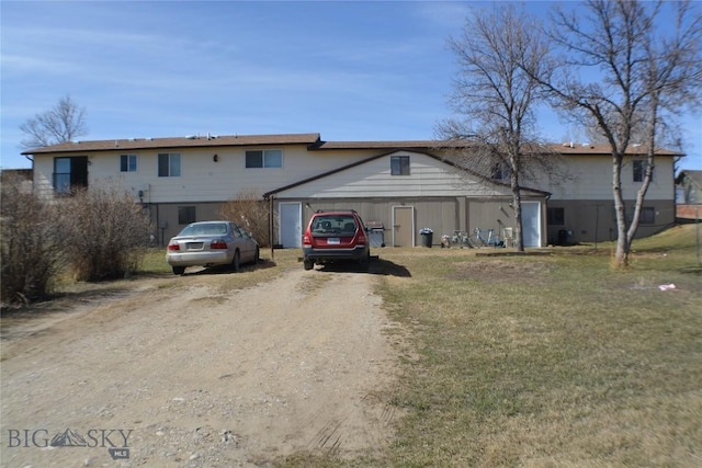 202 High St, Judith Gap, MT 59453 - view of front of house with an outdoor structure, a front yard, and dirt driveway