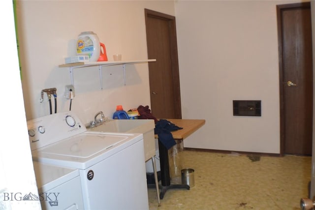 washroom with washing machine and clothes dryer and laundry area