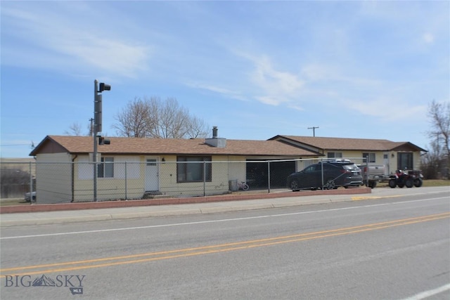 single story home with a fenced front yard