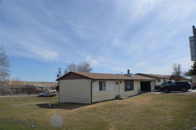 ranch-style home with a garage, driveway, and a front yard