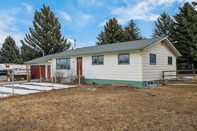 ranch-style house featuring a front yard and fence