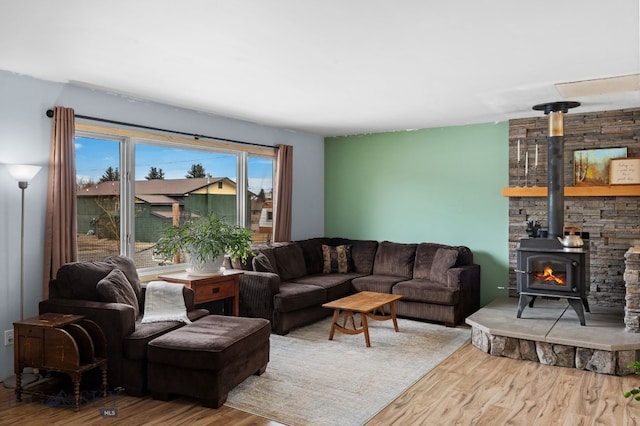 living room featuring wood finished floors and a wood stove