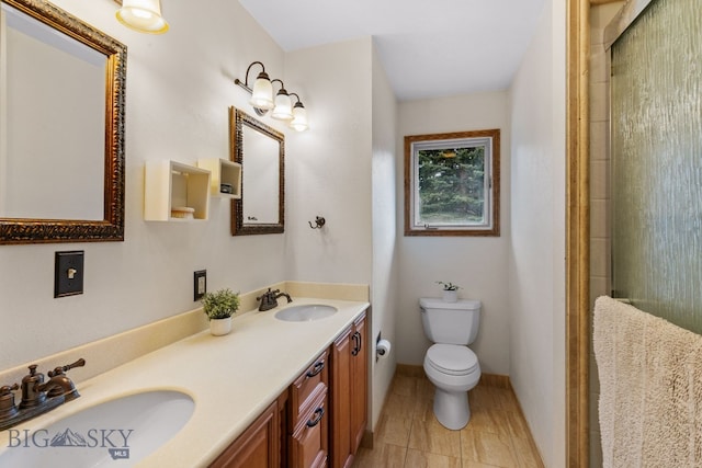 bathroom with a shower with door, toilet, and a sink