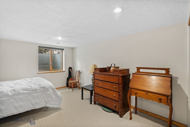 carpeted bedroom with recessed lighting, baseboards, and a textured ceiling