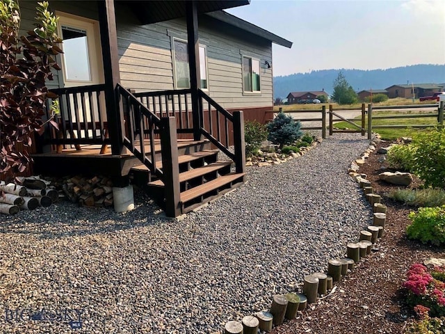 view of yard featuring fence and a mountain view