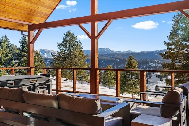 exterior space featuring a mountain view and outdoor lounge area