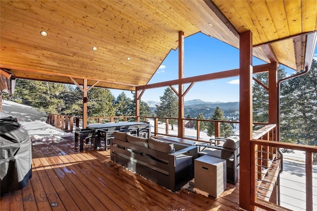 deck featuring outdoor lounge area, a mountain view, and grilling area