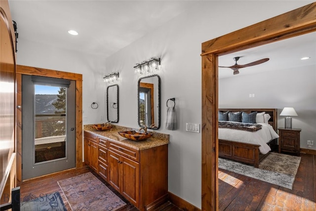 bathroom with baseboards, recessed lighting, hardwood / wood-style flooring, vanity, and a ceiling fan