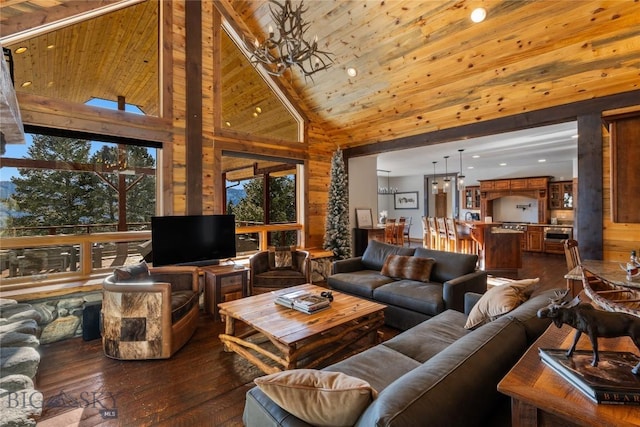 living room featuring high vaulted ceiling, dark wood-type flooring, a chandelier, and wooden ceiling