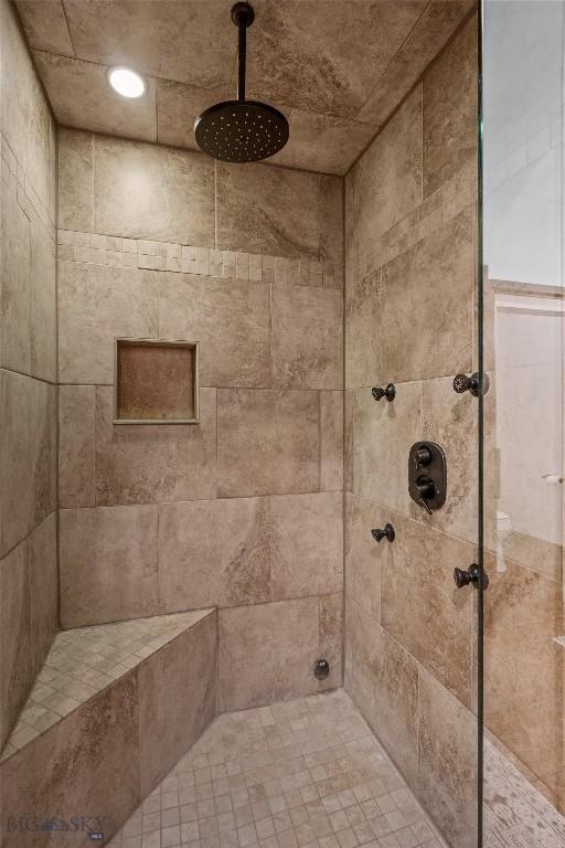 full bath featuring a tile shower